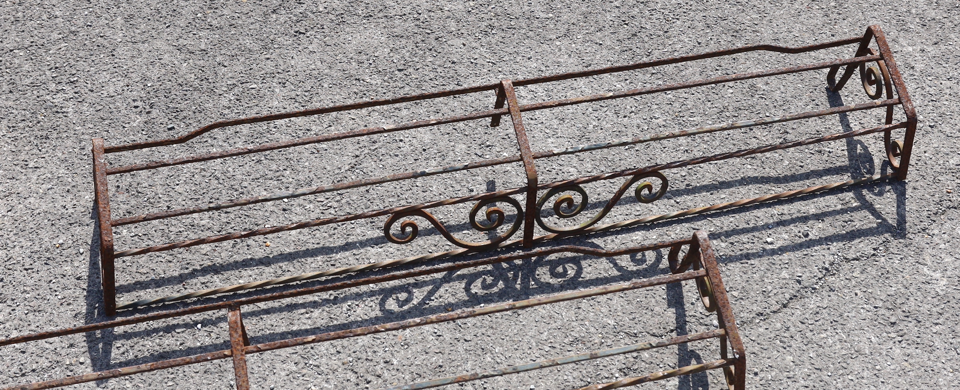 Three wrought iron pot stands and hangers, largest width 140cm